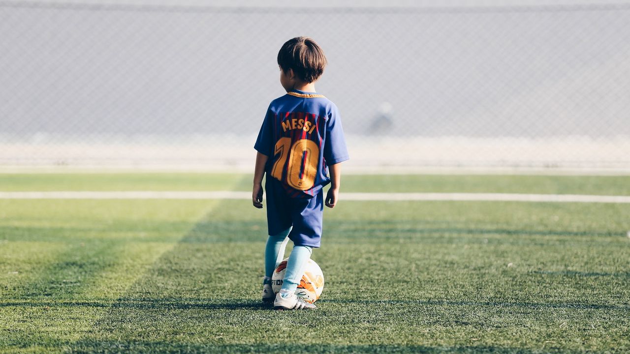 Wallpaper child, football player, football, football field, ball, lawn