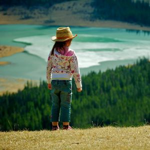 Preview wallpaper child, grass, hills, walking, nature, forest