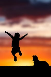 Preview wallpaper child, silhouette, jump, happiness, dog, sunset