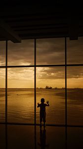 Preview wallpaper child, window, silhouette, sea, clouds, sunset