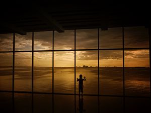 Preview wallpaper child, window, silhouette, sea, clouds, sunset