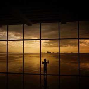 Preview wallpaper child, window, silhouette, sea, clouds, sunset