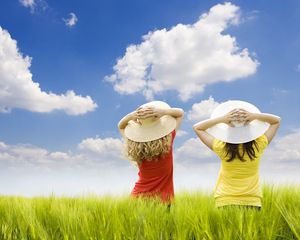 Preview wallpaper children, field, girls, hats, air, grass, sky