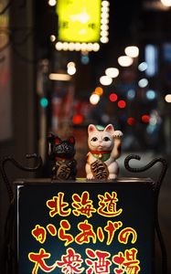 Preview wallpaper chinese figurines, figurines, hieroglyphs, street