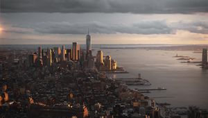 Preview wallpaper city, aerial view, buildings, coast, sunset, dusk