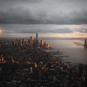 Preview wallpaper city, aerial view, buildings, coast, sunset, dusk