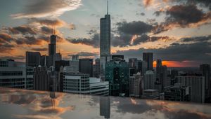 Preview wallpaper city, aerial view, buildings, sunset, reflection