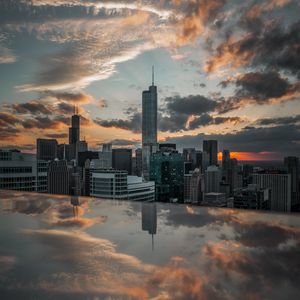 Preview wallpaper city, aerial view, buildings, sunset, reflection