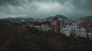 Preview wallpaper city, aerial view, buildings, trees, clouds