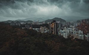 Preview wallpaper city, aerial view, buildings, trees, clouds