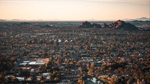 Preview wallpaper city, aerial view, buildings, trees, mountains, cityscape