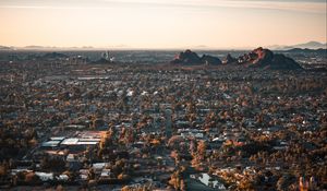 Preview wallpaper city, aerial view, buildings, trees, mountains, cityscape