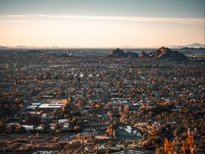 Preview wallpaper city, aerial view, buildings, trees, mountains, cityscape