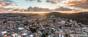 Preview wallpaper city, aerial view, buildings, mountains, sunset