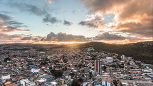 Preview wallpaper city, aerial view, buildings, mountains, sunset