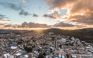 Preview wallpaper city, aerial view, buildings, mountains, sunset