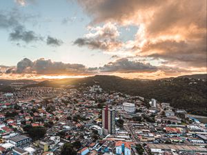 Preview wallpaper city, aerial view, buildings, mountains, sunset