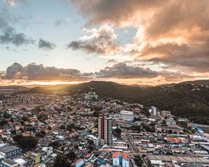 Preview wallpaper city, aerial view, buildings, mountains, sunset