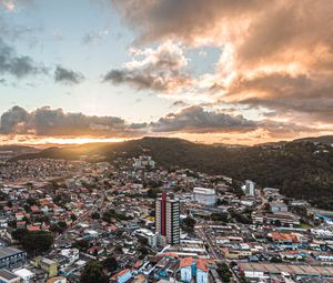 Preview wallpaper city, aerial view, buildings, mountains, sunset