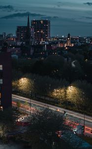 Preview wallpaper city, aerial view, buildings, road, trees, twilight