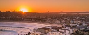 Preview wallpaper city, aerial view, coast, sunset, sea, beach, buildings