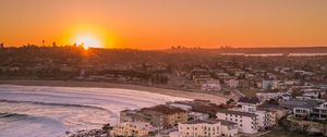 Preview wallpaper city, aerial view, coast, sunset, sea, beach, buildings