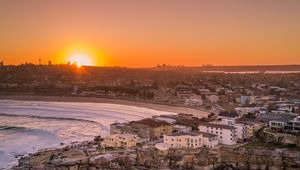 Preview wallpaper city, aerial view, coast, sunset, sea, beach, buildings