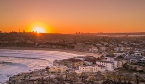 Preview wallpaper city, aerial view, coast, sunset, sea, beach, buildings