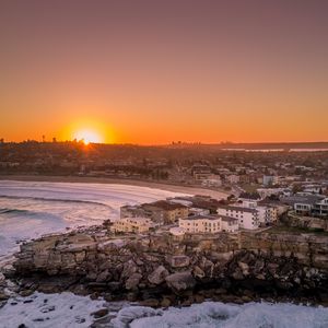Preview wallpaper city, aerial view, coast, sunset, sea, beach, buildings