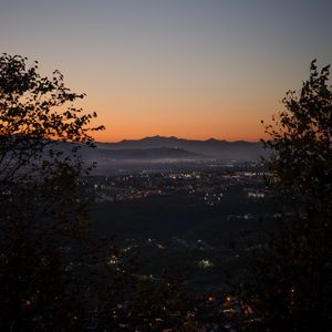 Preview wallpaper city, aerial view, mountains, sunset