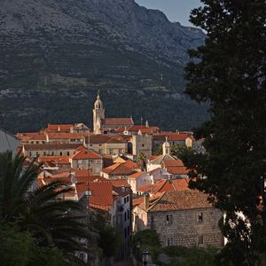 Preview wallpaper city, architecture, buildings, road, rocks