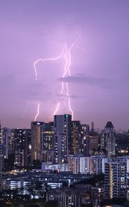 Preview wallpaper city, architecture, buildings, lightning, evening