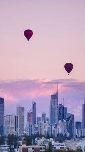 Preview wallpaper city, balloon, sunset, buildings