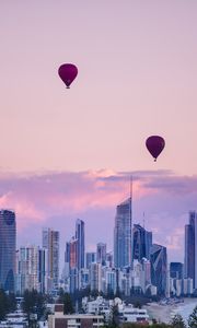 Preview wallpaper city, balloon, sunset, buildings