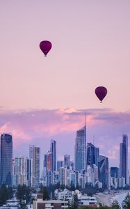 Preview wallpaper city, balloon, sunset, buildings