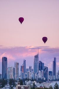 Preview wallpaper city, balloon, sunset, buildings