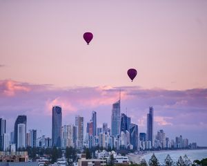 Preview wallpaper city, balloon, sunset, buildings