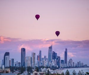 Preview wallpaper city, balloon, sunset, buildings