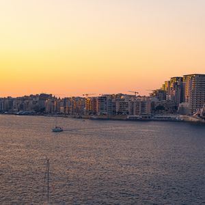 Preview wallpaper city, boats, buildings, water, dusk