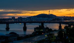 Preview wallpaper city, bridge, river, road, hill, evening, twilight