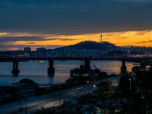 Preview wallpaper city, bridge, river, road, hill, evening, twilight