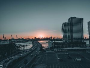 Preview wallpaper city, bridge, sea, sunset