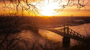 Preview wallpaper city, bridge, sunset, branches
