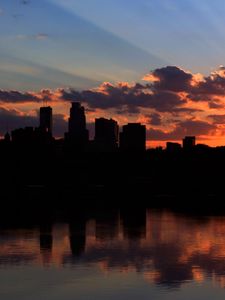 Preview wallpaper city, building, sky, sunset, clouds, river, sea