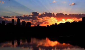 Preview wallpaper city, building, sky, sunset, clouds, river, sea