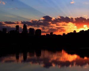 Preview wallpaper city, building, sky, sunset, clouds, river, sea