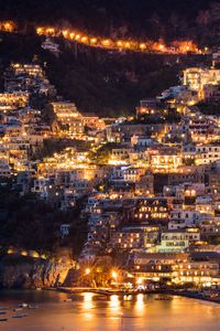 Preview wallpaper city, buildings, aerial view, lights, coast, hilly