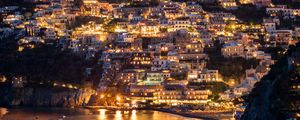 Preview wallpaper city, buildings, aerial view, lights, coast, hilly