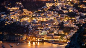 Preview wallpaper city, buildings, aerial view, lights, coast, hilly