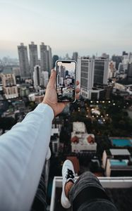 Preview wallpaper city, buildings, aerial view, hand, phone, overview